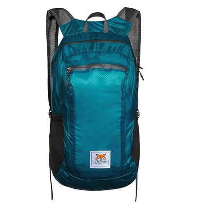 A teal and black backpack with a front zippered pocket and a small square logo patch featuring a fox and the text 'Duck Pack' on a white background.